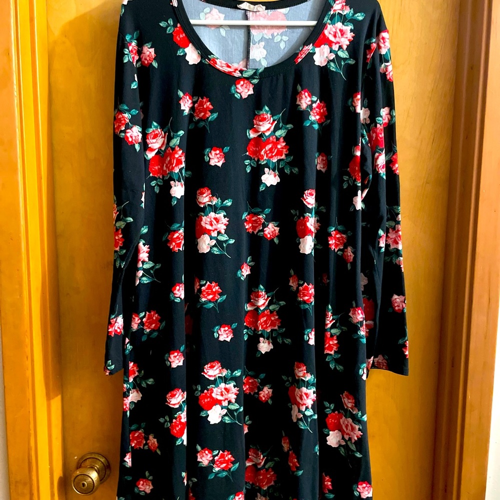 This is an adorable black dress with rose clusters.
